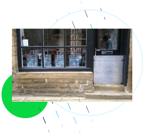A flood barrier in use protecting a gift shop in Hebden Bridge.