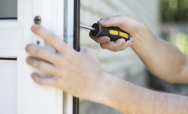 A tradesman fitting a flood door.