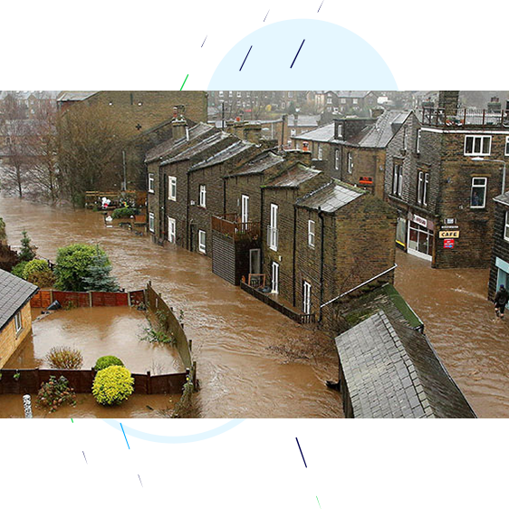 Rooftop footage showing rows of terrace houses and shops/cafes completely submerged in flood water.