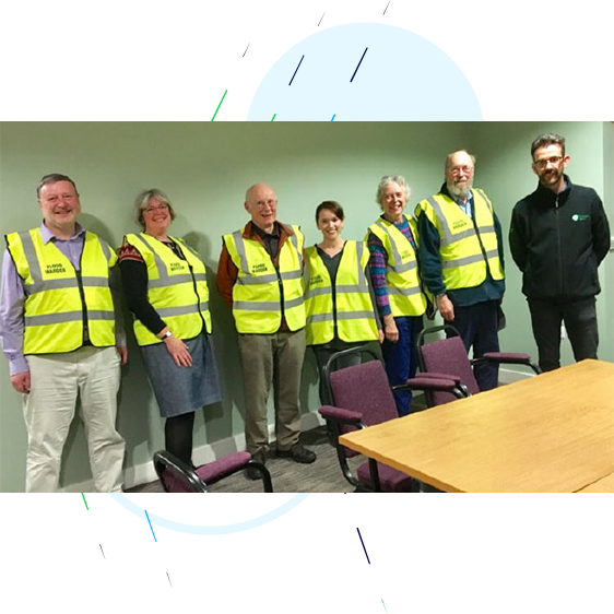Flood warden volunteers pictures with an Environment Agency representative.