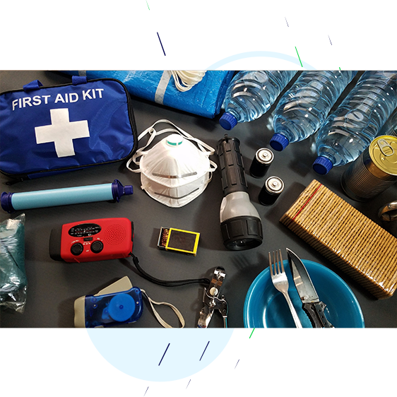Contents of a flood pack including, a torch, a battery operated radio, knife and fork, bottled water, tinned food and a first aid kit.