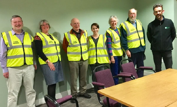 Flood warden volunteers pictures with an Environment Agency representative.