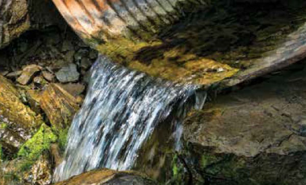 Picture shows how to manage a watercourse well by installing correct drainage.