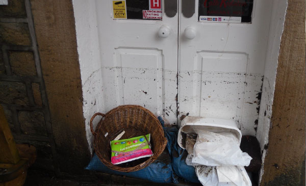 Dirty flood water residue left on a white double door shows how high the water level rose.