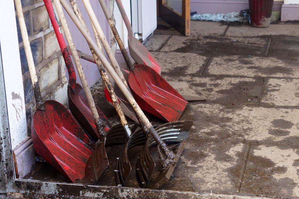 Muddy shovels, brushes and other cleaning equipment left outside.