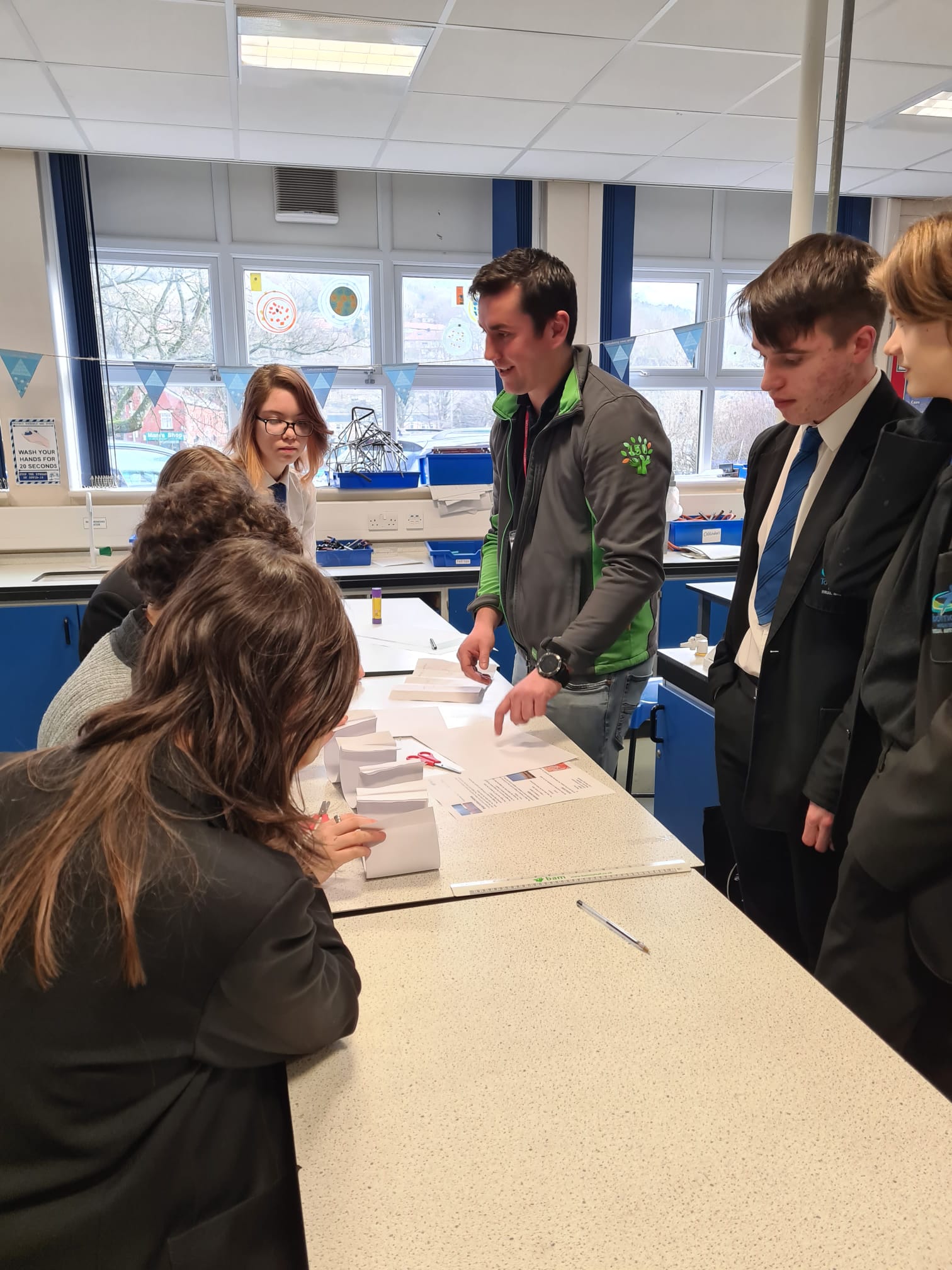 Site Agent, Liam, working with Year 10 Students at Todmorden High School on a Paper Bridge Building Challenge