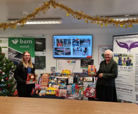 Social Value Manager, Rebecca, with Calder Community Cares Volunteer and Hebden Royd Town Councillor, Bernice Hayes. Handing over gifts collected for local families by Bam Nuttall, Environment Agency, Mott Macdonald & Arup Staff.