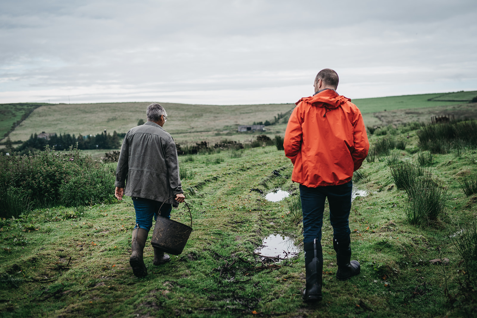 Landowner and natural flood management officer walk through fields together