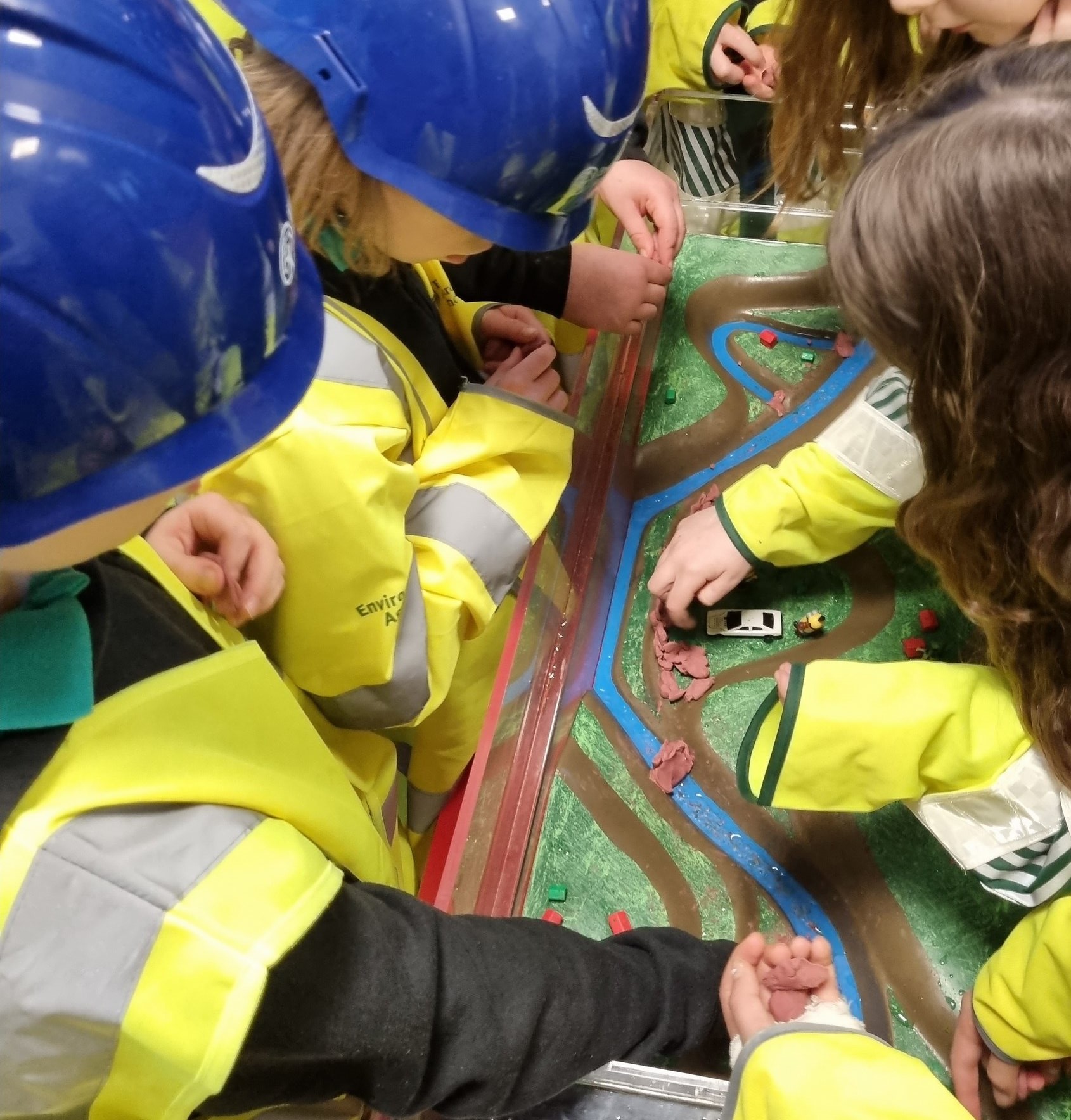 Riverside Junior school children learning by playing with a flood tank model.