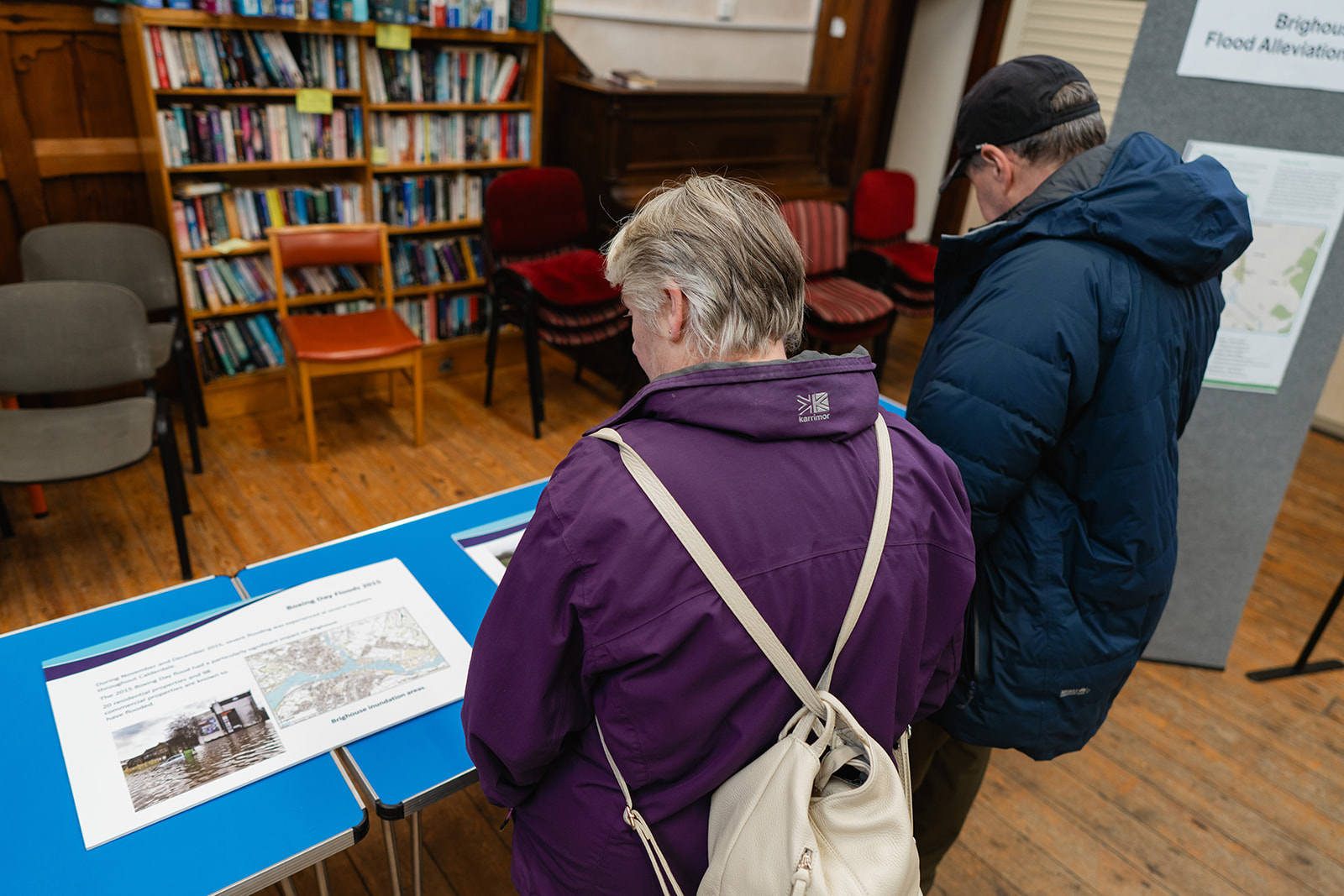 People viewing past flooding interpretation boards at the Brighouse drop in event.