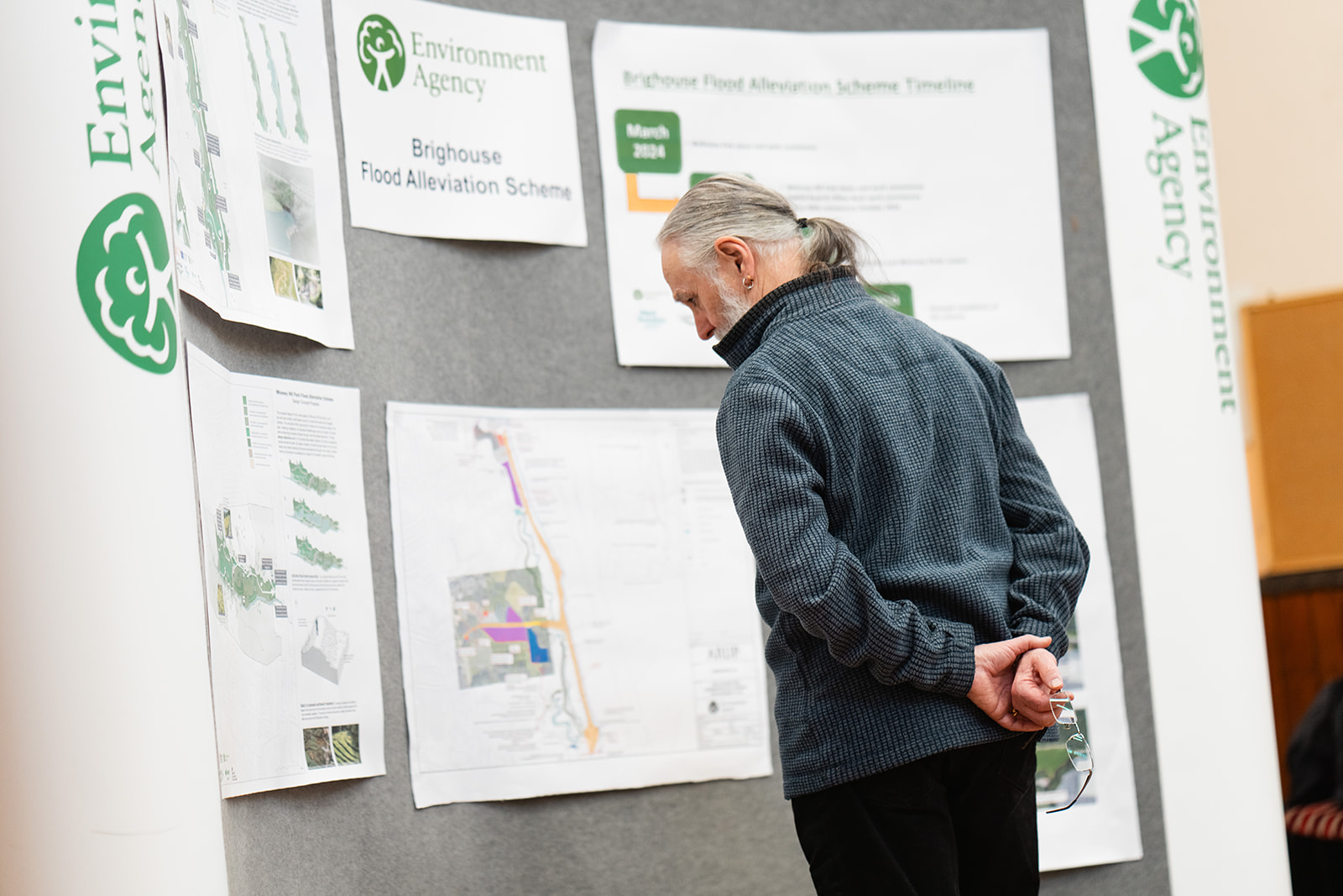 Man looks at flood alleviation scheme plans at the Brighouse drop in event.