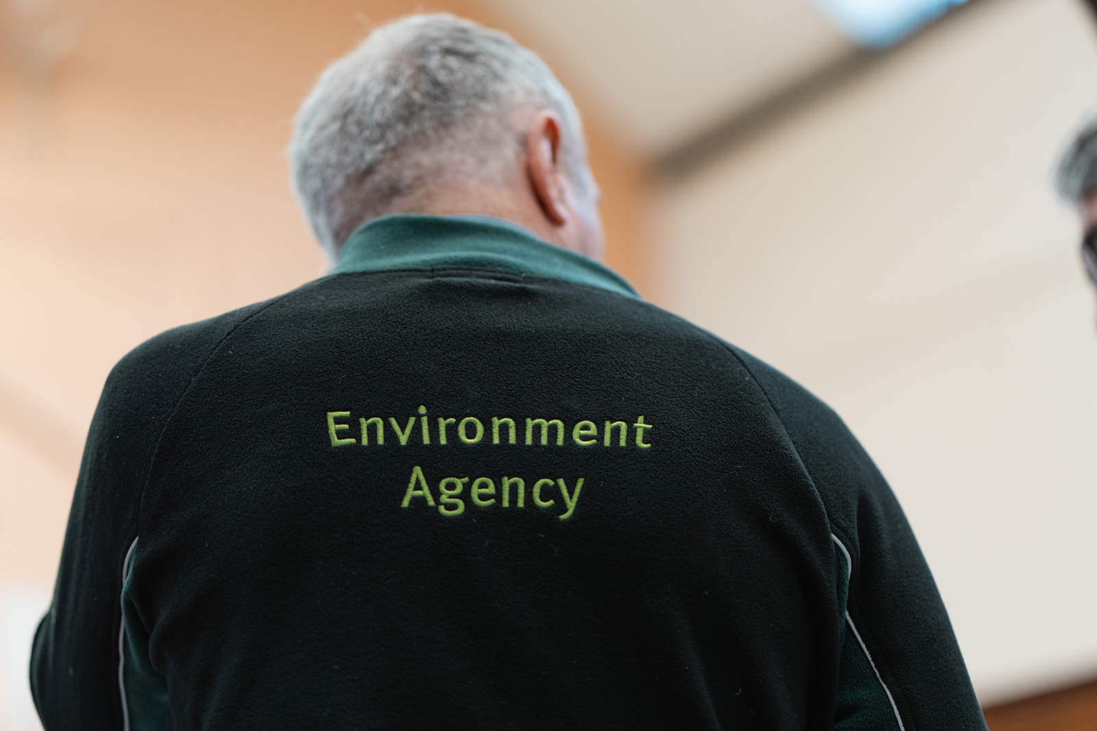 Environment Agency worker wears an Environment Agency fleece.