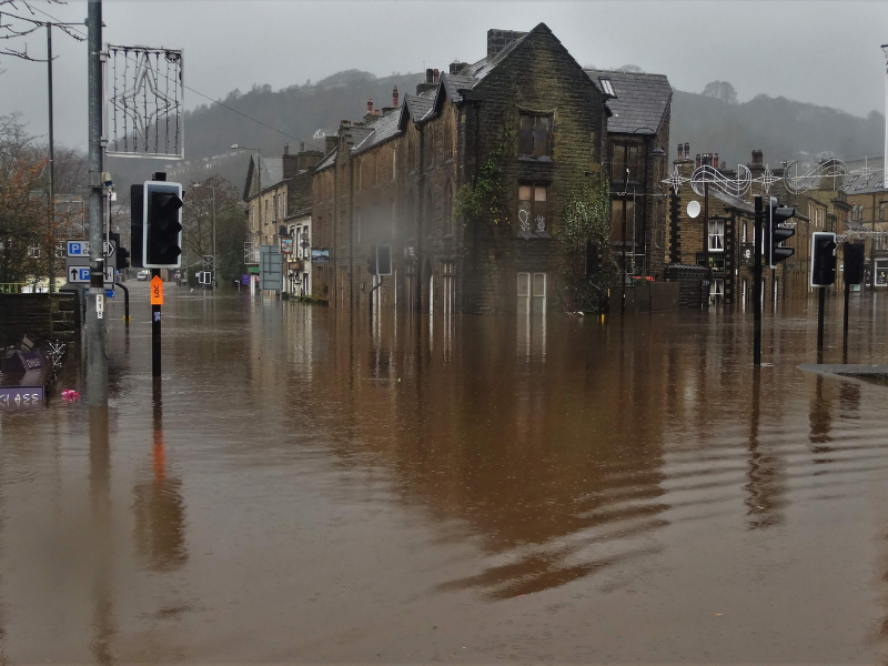Flooding in Calderdale on Boxing Day 2015. Streets are flooded with brown water.