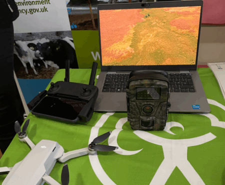A table at a careers stall for the Environment Agency shows a laptop and drone with controls