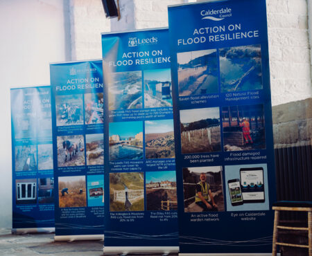 Banner stands ar West Yorkshire Flood Summit that highlight key achievements for local authorities