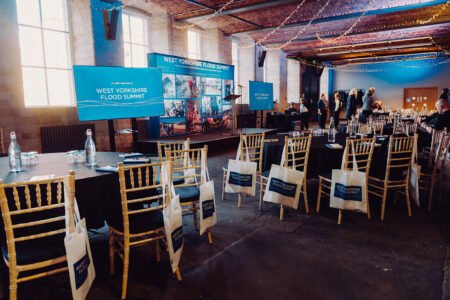 West Yorkshire Flood Summit venue with branded bags on chairs