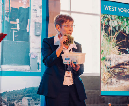 Councillor Jane Scullion, Leader of Calderdale Council speaking at the West Yorkshire Flood Summit - holding a bowl of sphagnum moss.