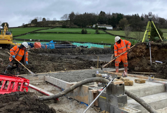 Construction work at Cottonstones Mill Pond. The image shows constructions equipment and workers.