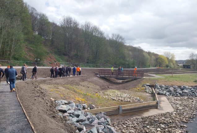 Members attending the Regional Flood and Costal Committee meeting walk along the river viewing the Brighouse Flood Alleviation Scheme