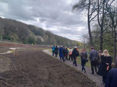 Members attending the Regional Flood and Costal Committee meeting walk along the river viewing the Brighouse Flood Alleviation Scheme