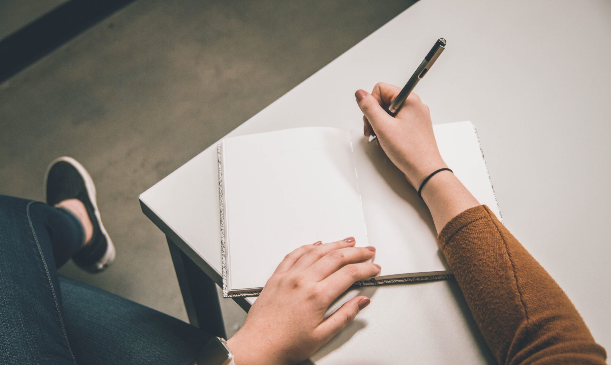 Hand with pen and paper.