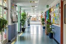 A-British-school-hallway-decorated-with-student-projects-and-a-trophy-cabinet