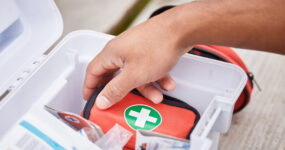 High angle shot of a male looking in his first aid kit.